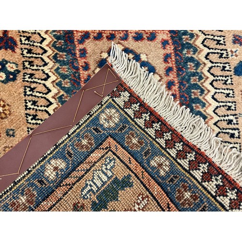 2060A - A North West Persian Yallemeh runner carpet, or rug, knotted with a row of four diamond-shaped medal... 