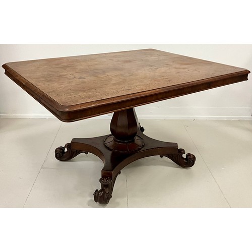 1699A - A Regency mahogany centre table, the rounded rectangular top with moulded edge, raised on a turned o... 