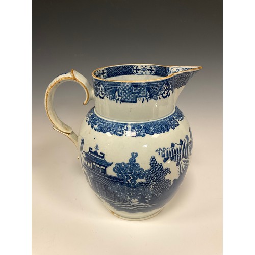 1161A - A Leeds pottery pearlware water jug, transfer printed in the long Bridge pattern, 22.4cm high, gradu... 