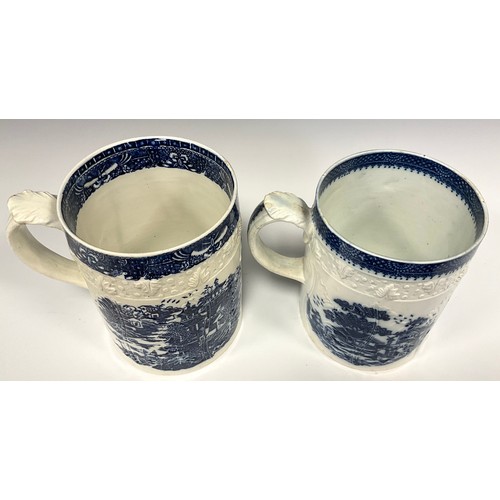 1155A - A late 18th/early 19th century pearlware blue and white mug, transfer printed with Chinoiserie lands... 