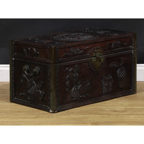 1535A - A Chinese hardwood rectangular chest, carved in relief with precious objects, characters and an elep... 