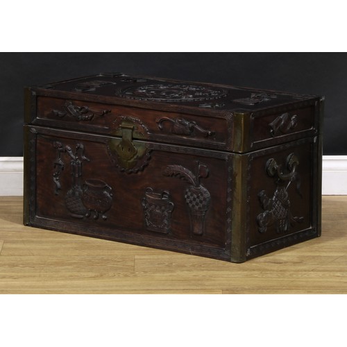 1535A - A Chinese hardwood rectangular chest, carved in relief with precious objects, characters and an elep... 