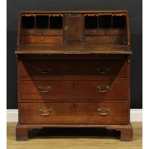 2159 - A George III oak bureau, fall front enclosing a fitted interior above four long graduated drawers, b... 