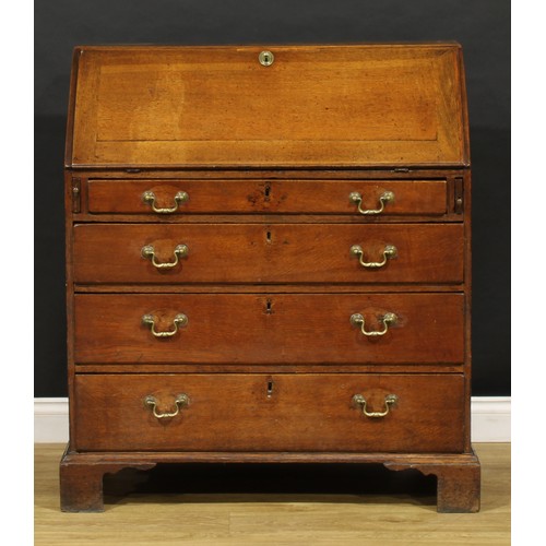 2159 - A George III oak bureau, fall front enclosing a fitted interior above four long graduated drawers, b... 