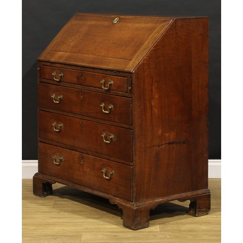 2159 - A George III oak bureau, fall front enclosing a fitted interior above four long graduated drawers, b... 