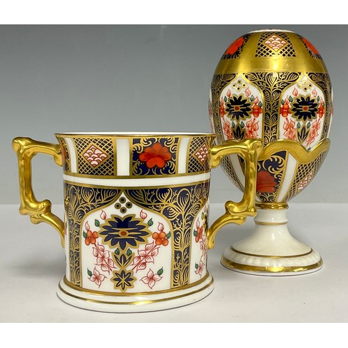 26 - A Royal Crown Derby 1128 Imari pattern egg and stand, solid gold band, 13cm high, second quality, no... 