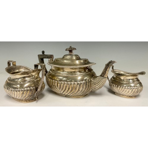 44 - A late Victorian silver composed half fluted three-piece tea service, the teapot, London 1898, the c... 