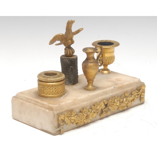 79 - A French Empire style inkstand, central bronze eagle flanked by campana and basket shaped ormulu ink... 