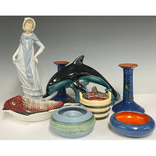 137 - A large Poole pottery dolphin; a Nao by Lladro figure, Lady with Bonnet and Scarf; a pair of torquey... 