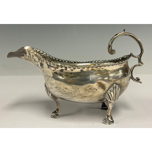 149 - A George IV silver sauce boat, hammered rim, scroll handle, hoof feet, Edinburgh 1819, 100g