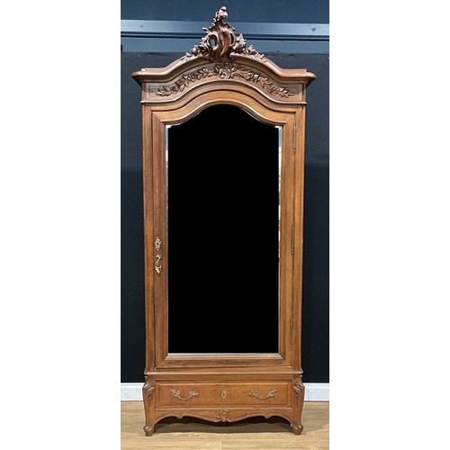 108 - A French Provincial design armoire, in the vernacular Louis XV taste, chapeau de gendarme cresting a... 