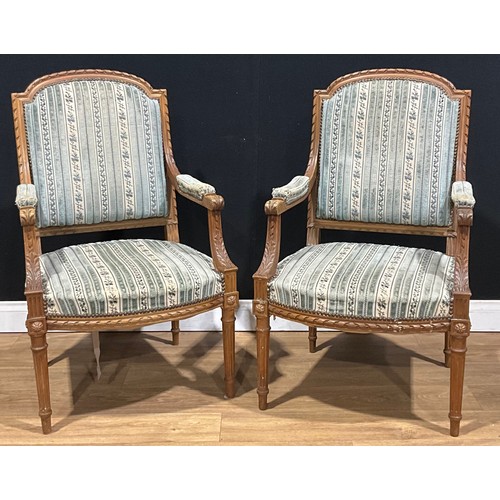 109 - A pair of Louis XVI Revival open armchairs, 99cm high, 59cm wide, the seat 50.5cm deep, first-half 2... 