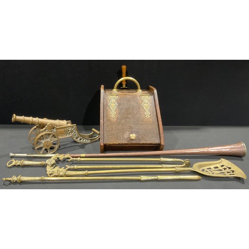 335 - An Arts & Crafts oak fuel bin, brass fittings, 43cm long; a large brass fireside cannon, 43cm long; ... 