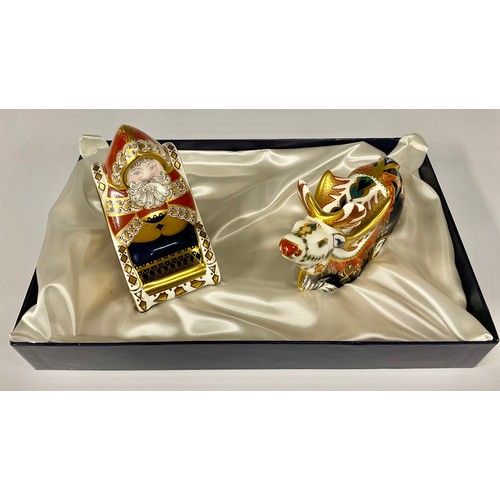 186 - A Royal Crown Derby paperweight set, comprising Santa in Sleigh and a Reindeer with red nose, gold s... 