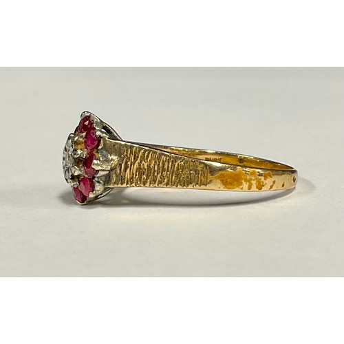 501 - A ruby and diamond cluster ring, central round brilliant cut diamond surrounded by eight red rubies,... 