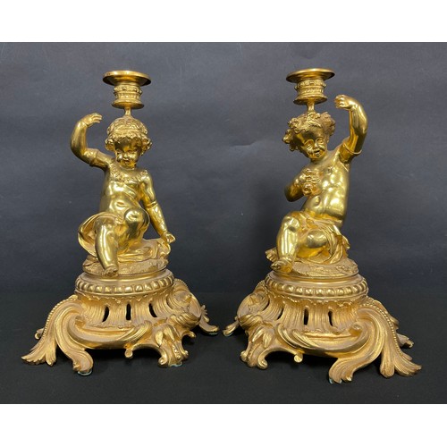 512 - ***LOT WITHDRAWN***A pair of Louis XV style gilt metal candlesticks, the flared sconce supported on ... 