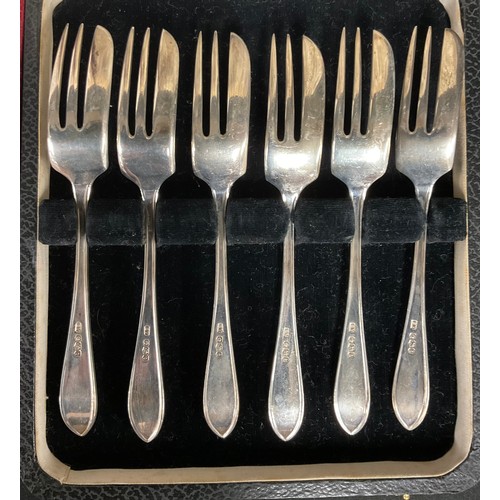 50 - A set of six silver teaspoons, Sheffield 1953, cased; a set of six silver dessert forks, Sheffield 1... 