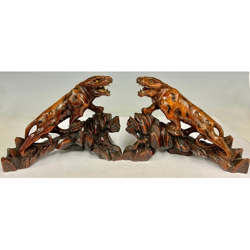 76 - A pair of 20th century Chinese hardwood root carvings of deities; in the form of tigers with inset g... 