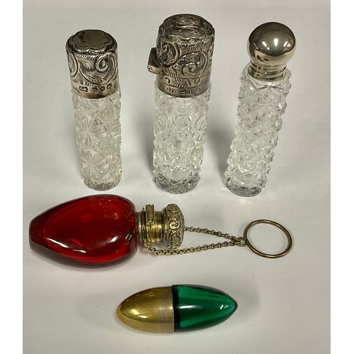 79 - A Victorian silver mounted scent bottle, the hinged cover chased with foliate scrolls, enclosing a g... 