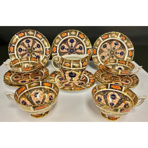 84 - A set of four Royal Crown Derby 1128 Imari pattern teacups, saucers and side plates, printed mark in... 