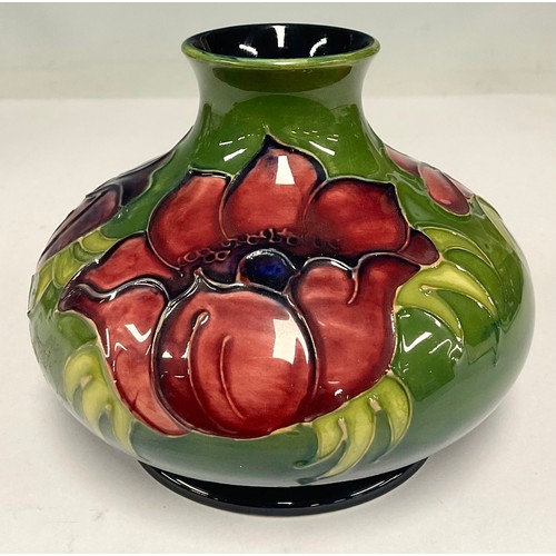 16 - A Moorcroft hibiscus pattern ovoid vase, tube lined with pink flowers on a graduated green and blue ... 