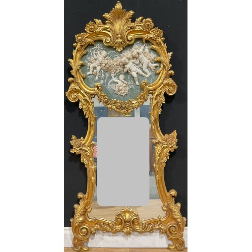 561 - A large Louis XV style gilt painted pier glass, in the Rococo taste, the shaped mirror plate crested... 