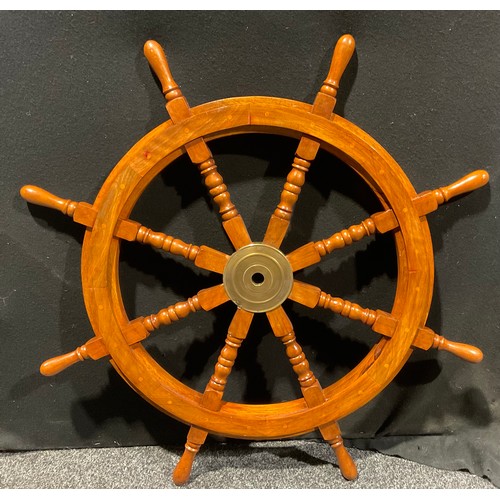 562 - A replica wooden ships wheel, 84.5cm high