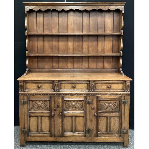 113 - A Titchmarsh and Goodwin oak dresser, plate-rack top, three short drawers to frieze, above three car... 