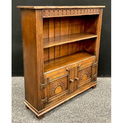 115 - A Titchmarsh and Goodwin oak bookcase cabinet, 91.5cm high x 84cm wide x 25cm deep.