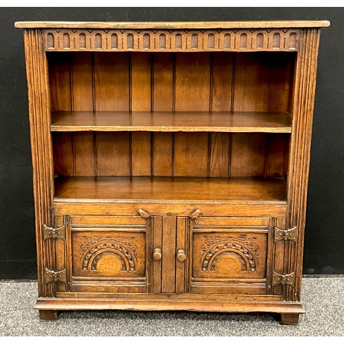 115 - A Titchmarsh and Goodwin oak bookcase cabinet, 91.5cm high x 84cm wide x 25cm deep.