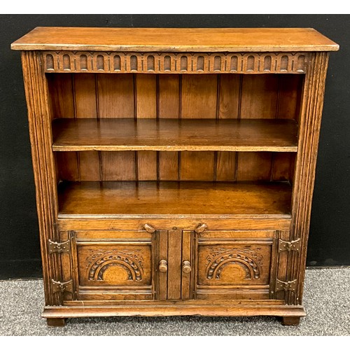 115 - A Titchmarsh and Goodwin oak bookcase cabinet, 91.5cm high x 84cm wide x 25cm deep.