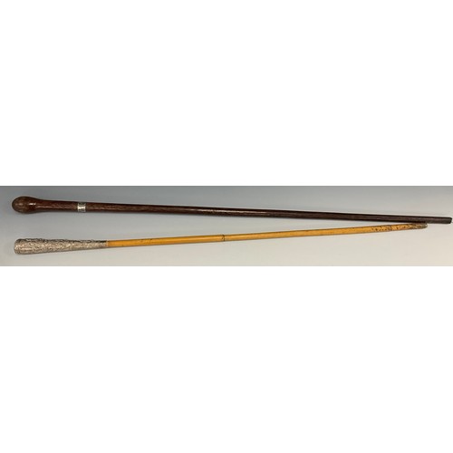 122 - An early 20th century walking stick, the white metal mounted pommel cast with graduated panels of Bu... 