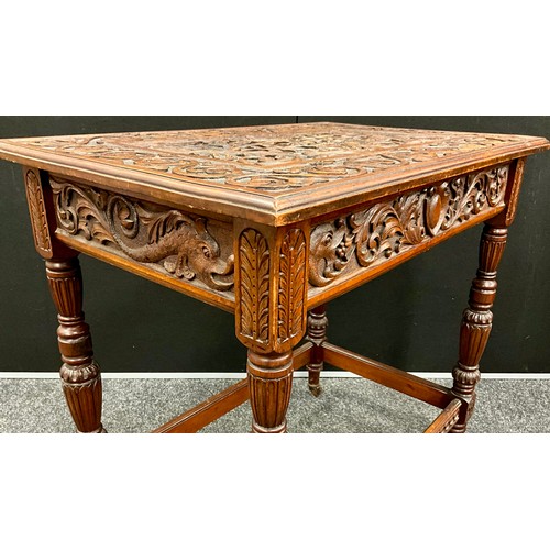 165 - A Victorian Jacobean revival carved oak side table, the top carved in relief with fruit-filled tazza... 