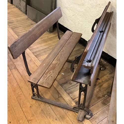 22 - A 19th century cast iron and pitch pine school bench desk, the sloping writing surface hinged to lif... 