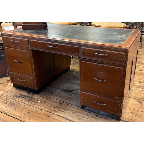 41 - A mahogany twin pedestal desk, each pedestal with filing drawers to one side, with cupboard opposite... 