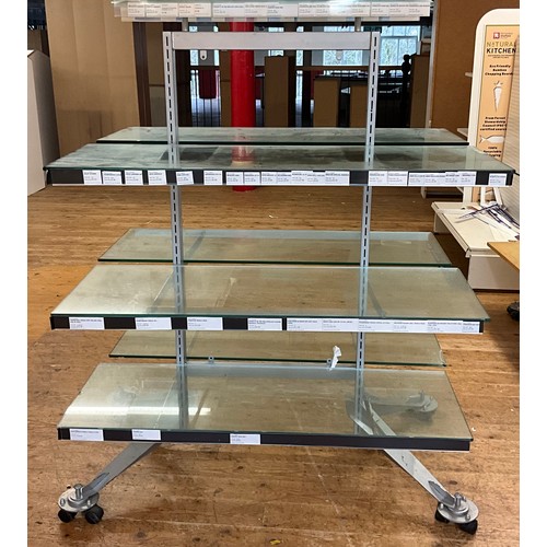 106 - A double sided glass display unit on casters, three shelves, topped with singular glass shelf, 150cm... 