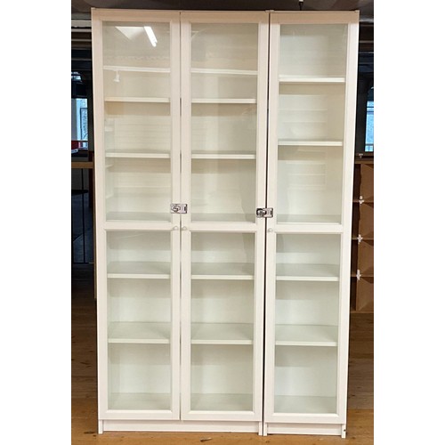 116 - A contemporary shop display cabinet with glazed doors, opening to six shelves, 202cm high, 122cm wid... 