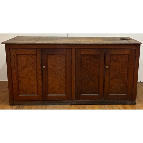 121 - A pine worktop sideboard, the doors set with curly heart pine panels, concealing two shelves, 91.5cm... 