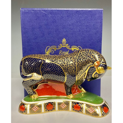 5031 - A Royal Crown Derby paperweight, Bull, Imari palette base, gold stopper, 19cm long, printed mark in ... 