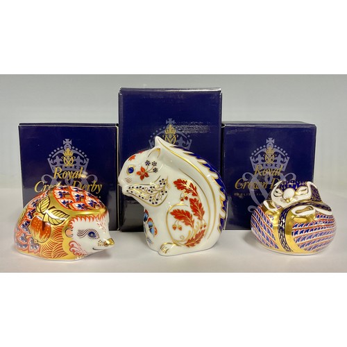 5058 - A Royal Crown Derby paperweight, Dormouse, gold stopper, 7.5cm long, printed mark in red, boxed; oth... 