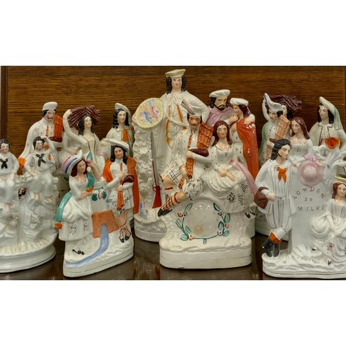 257 - A collection of 19th century Staffordshire figures including; Huntsman, 40cm high, ‘London 30 miles’... 