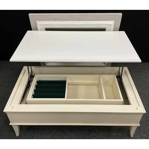 561 - A contemporary white painted coffee table / storage chest, with mechanised lift-up top, 41cm high x ... 