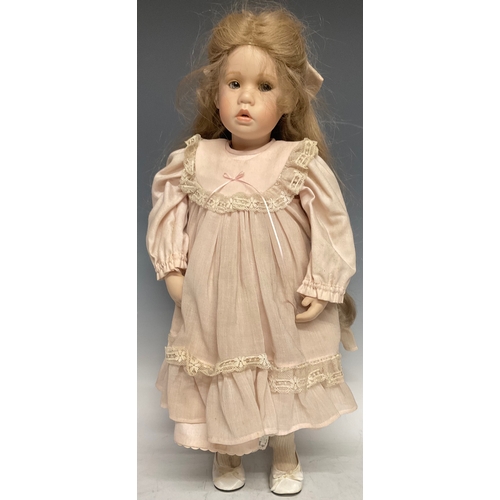 6408 - A 19th century style bisque head doll, blond hair, porcelain limbs, indistinctly signed,  51.5cm lon... 