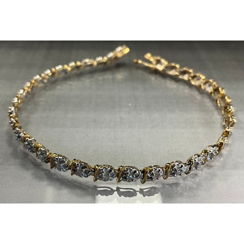 777 - A diamond tennis bracelet, thirty six illusion set diamond accents, 9ct gold mount, 18.5cm long, sta... 