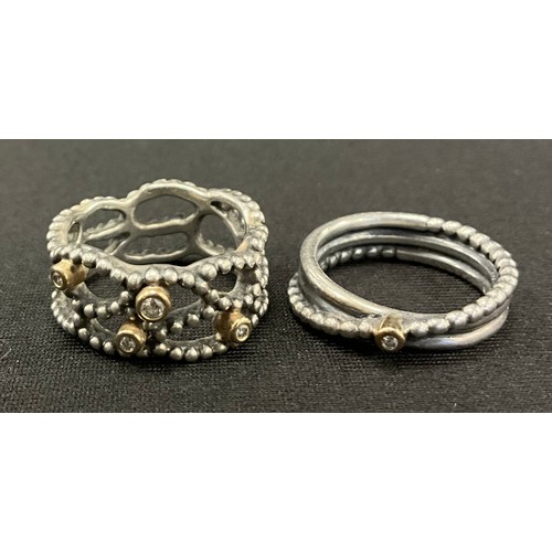 779 - A boxed Hot Diamond silver mounted open work shank dress ring, set with four rolled collar, round br... 