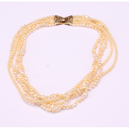 867 - A South Sea Islands five strand cultured and fresh water pearl necklace, with free form and globular... 