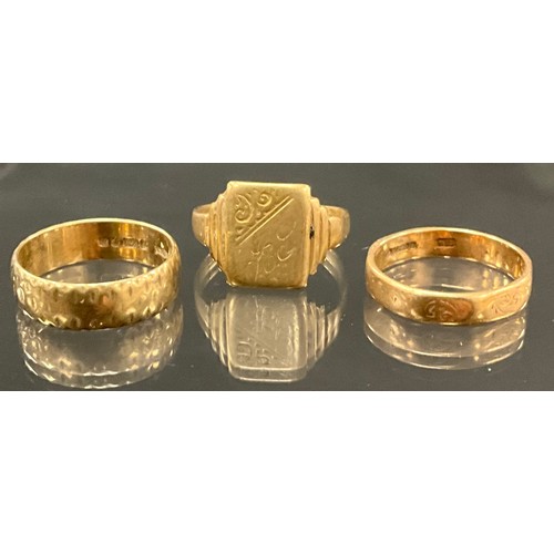 896 - A 9ct gold textured wedding band, size O, 3.3g;  another, plain octagonal, size N, 2.5g;  a 9ct gold... 