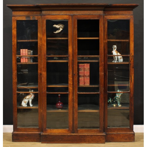 2460 - A Victorian rosewood library bookcase, outswept cornice above four doors enclosing adjustable shelve... 