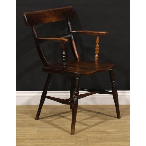 2468 - An early 19th century elm and beech bar back Windsor elbow chair, serpentine arms on bobbin-turned s... 