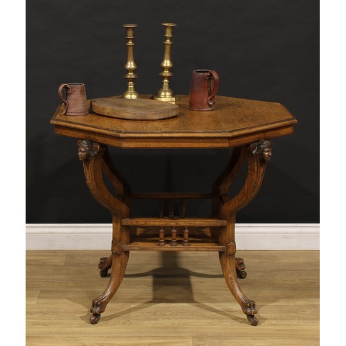 1527 - An unusual late 19th century oak octagonal centre table, moulded top above four carved mask corbels,... 